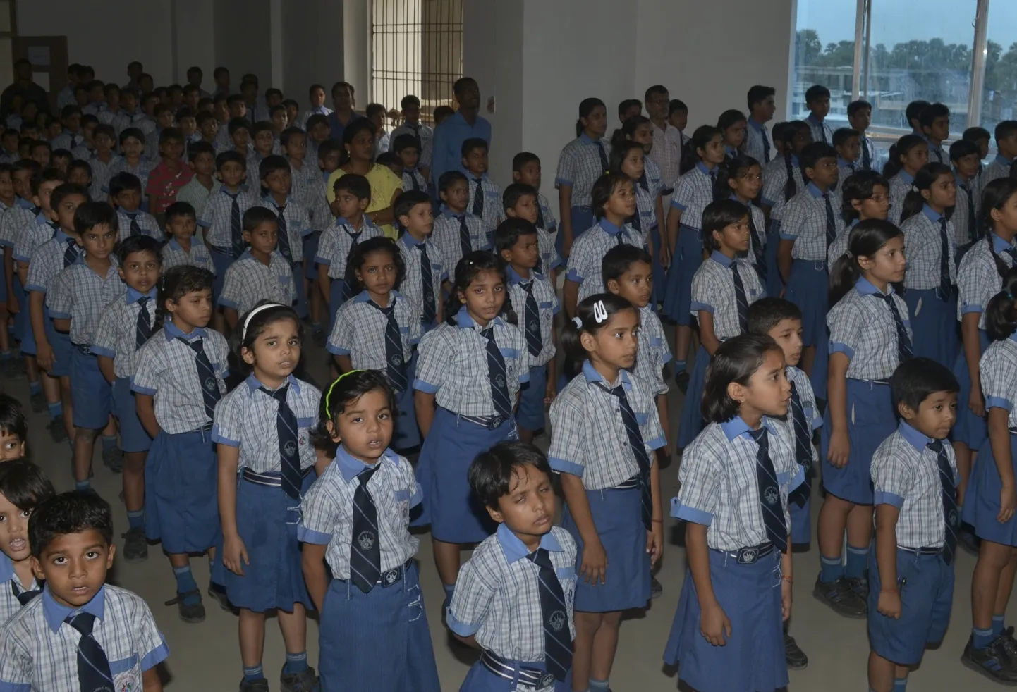Day scholars in uniform standing in rows at the morning assembly