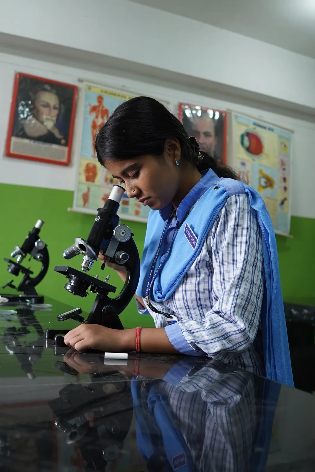 A student looking through a microscope in the biology laboratory