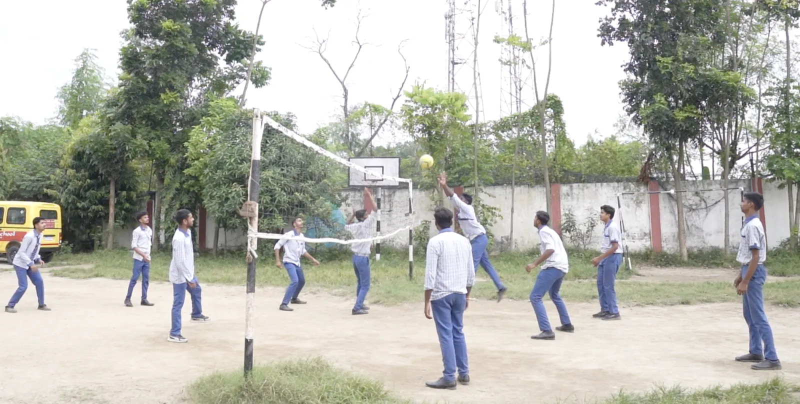 Senior students playing volleyball on the school ground