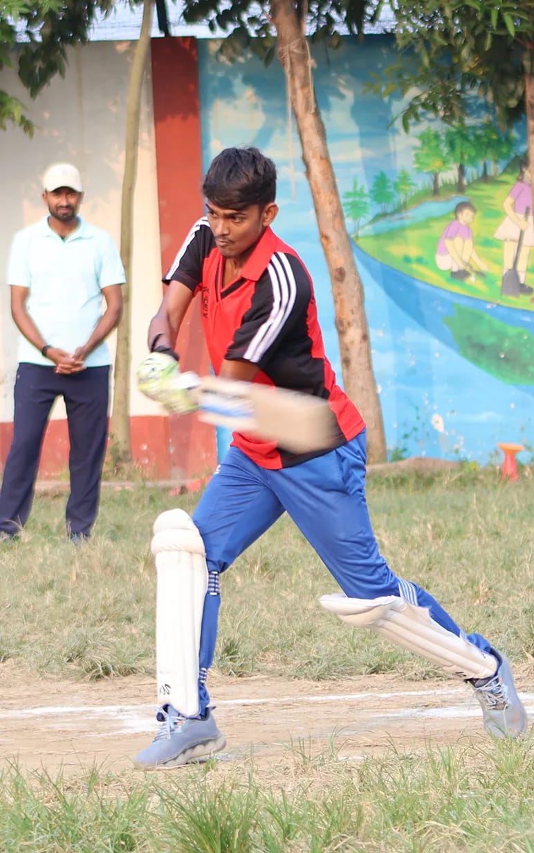 A batter in the red house kit stepping into a drive