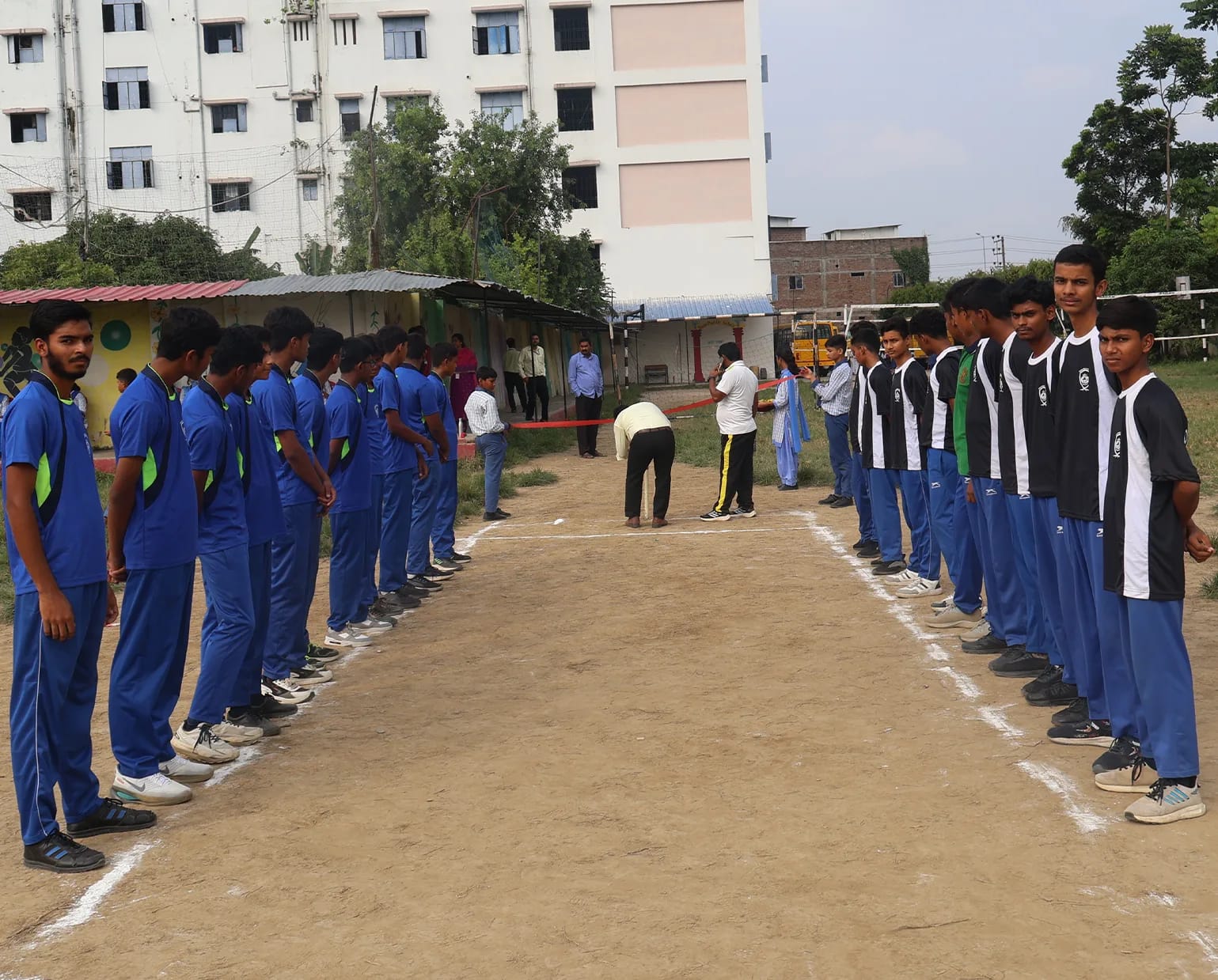 Two house teams lined up on either side of the pitch before a match