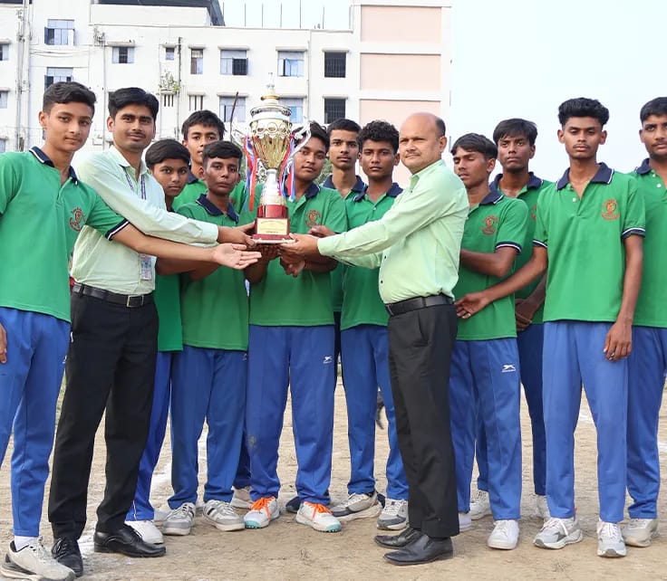 Ashoka House players in green receiving their trophy from teachers