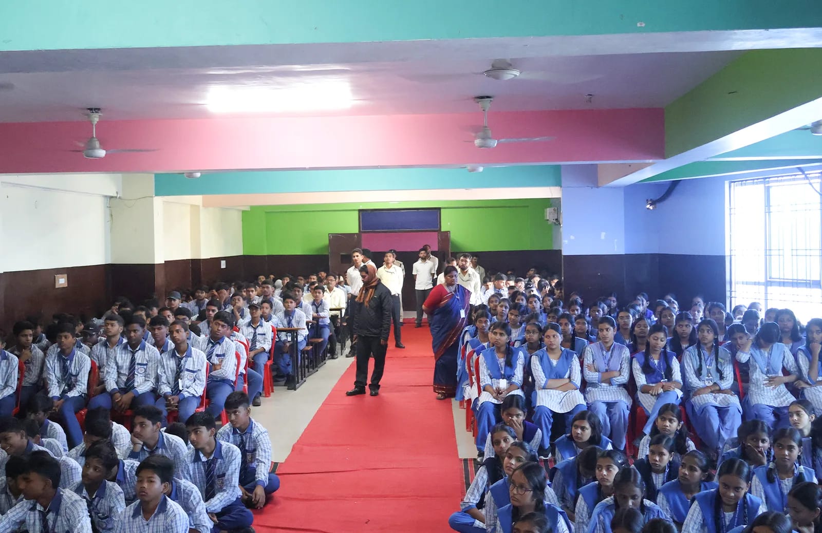 Students seated in the school hall for the Surakshit Bachpan Abhiyan programme