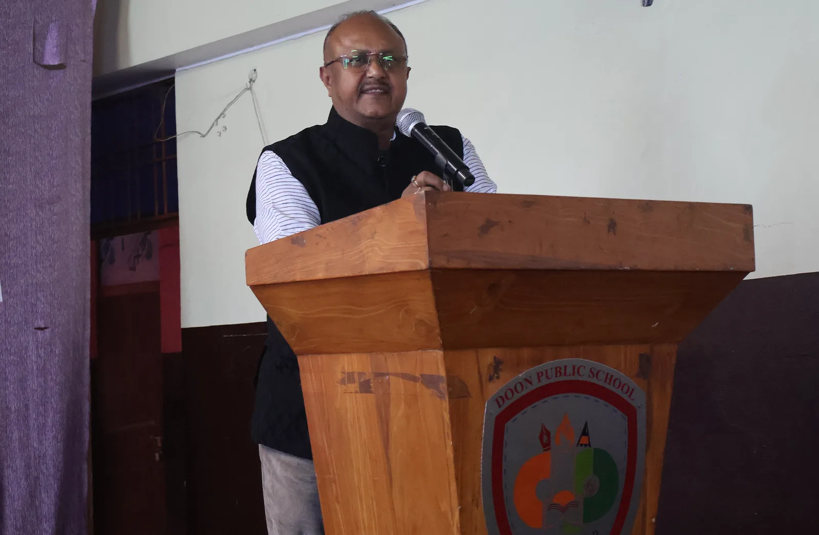 A guest addressing the students from the school podium