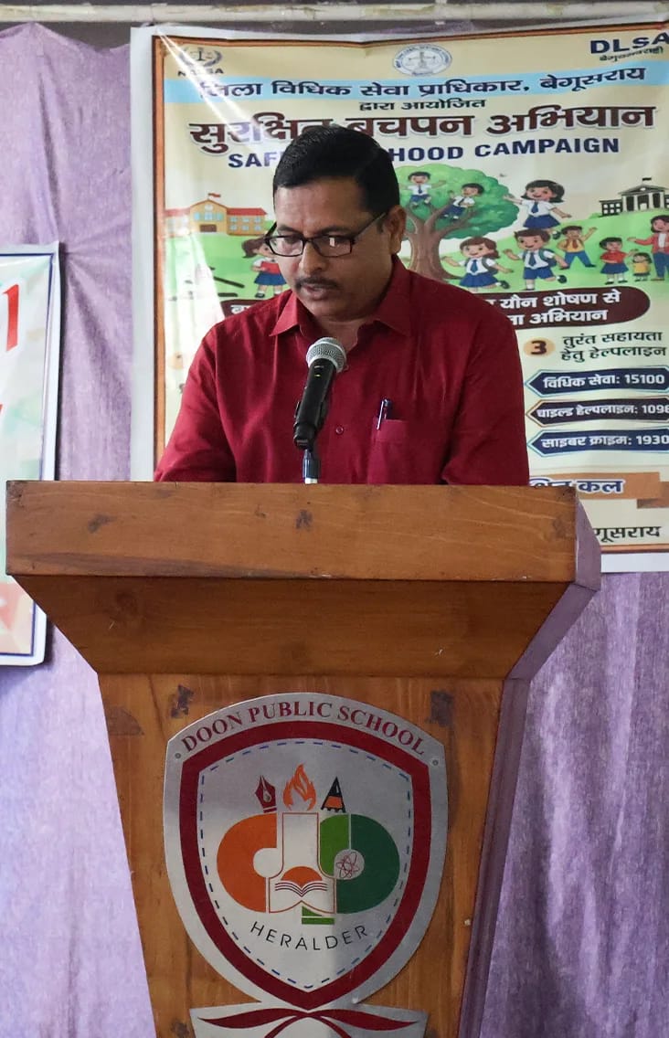 A guest speaking at the podium beside the campaign banner